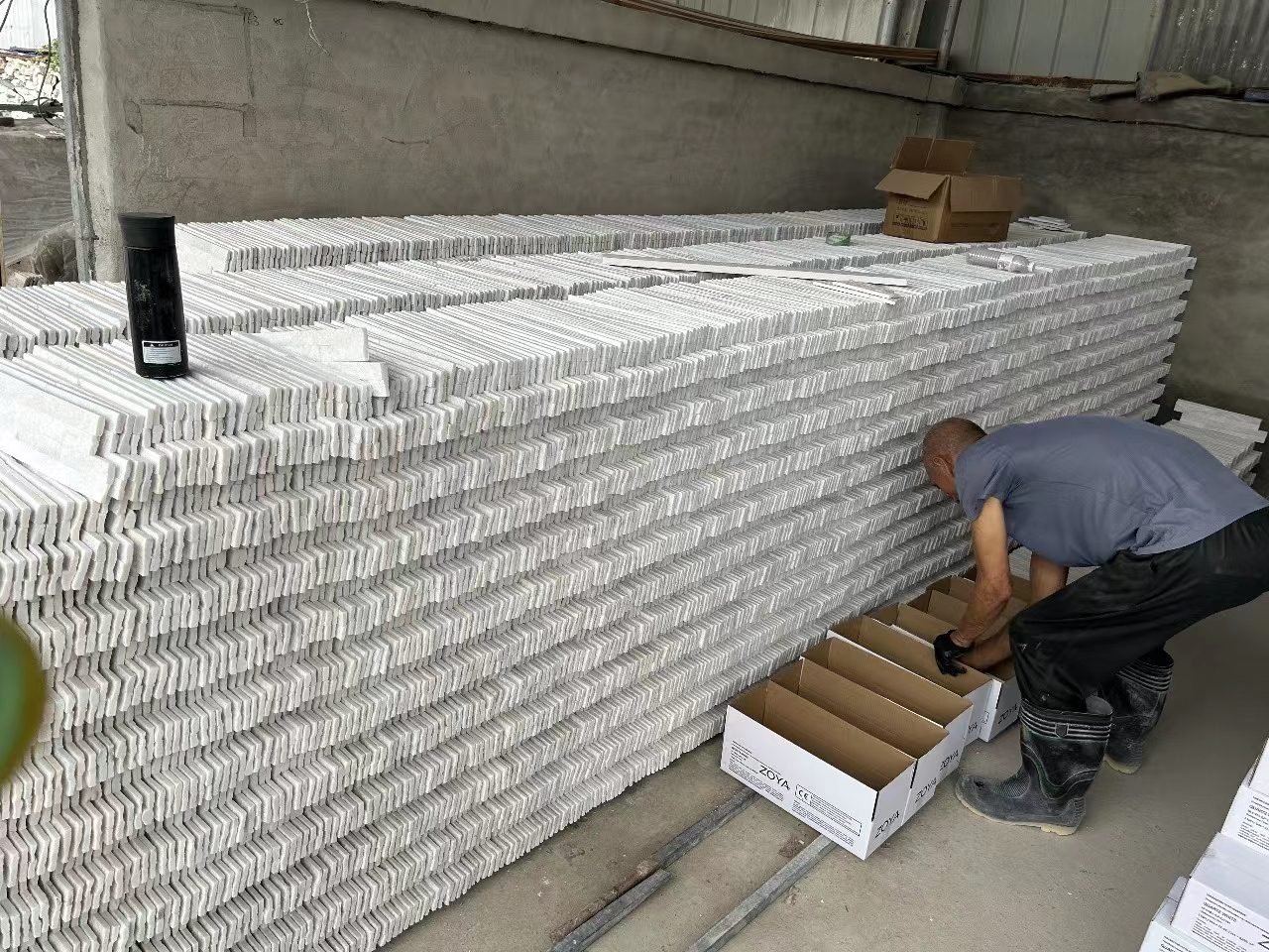 factory worker packing white quartz mini ledgestone