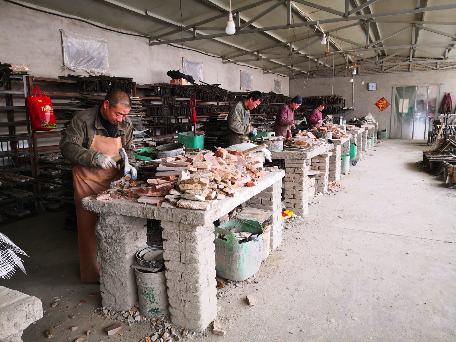 Factory workers producing cement backed stone veneer panels in the Top Stone Panels manufacturing facility