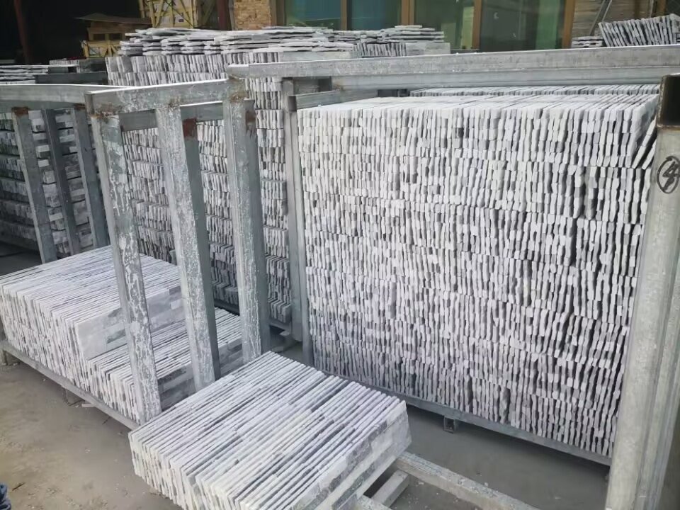 Top Stone Panels factory workshop with infrared CNC cutting lines and hand-laid stone panel assembly
