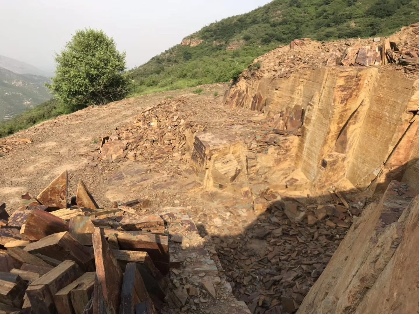 Hebei natural slate quarry face showing layered stone extraction benches