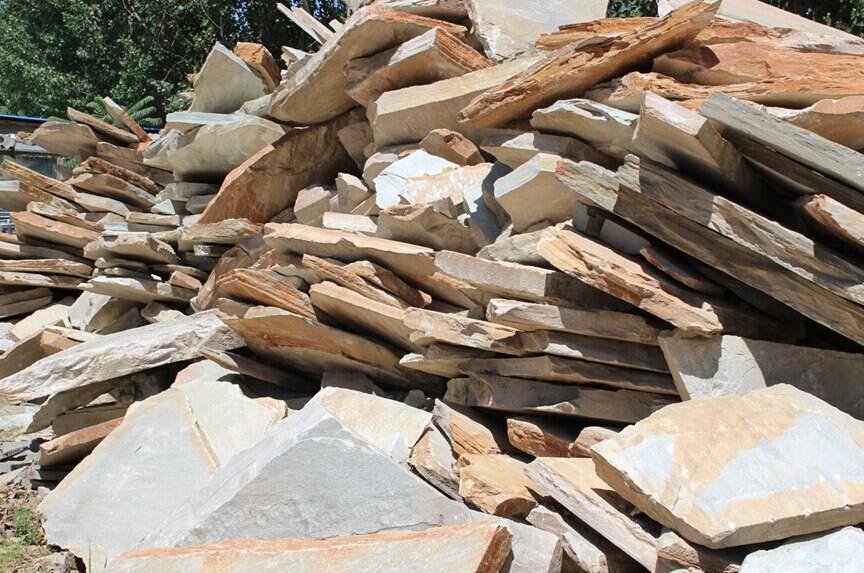 Large beige quartzite rough blocks freshly extracted from a quarry awaiting cutting