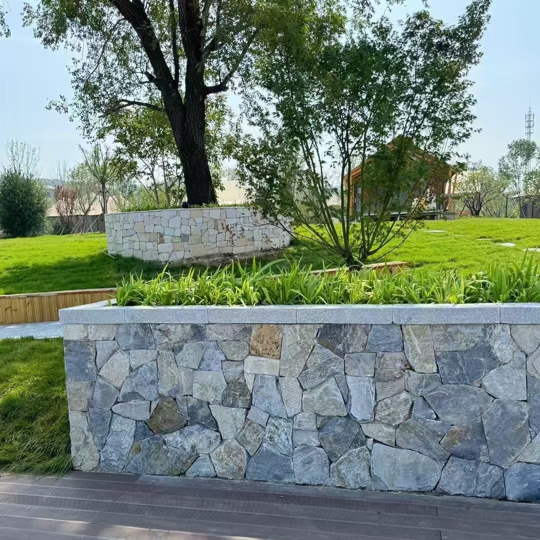 loose natural stone slabs and ledges built as a waterfall spillway and pond cascade, splash zone bedded for drainage, from Top Stone Panels - photo 12