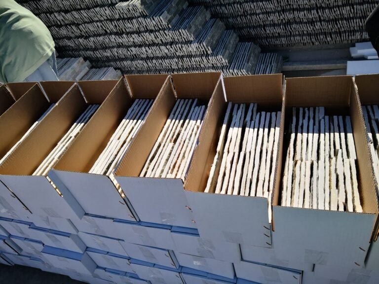 open carton box showing split face stone tiles inside - export packing of thin ledgestone panels, carton and reinforced crating for container loading with landed freight optimization