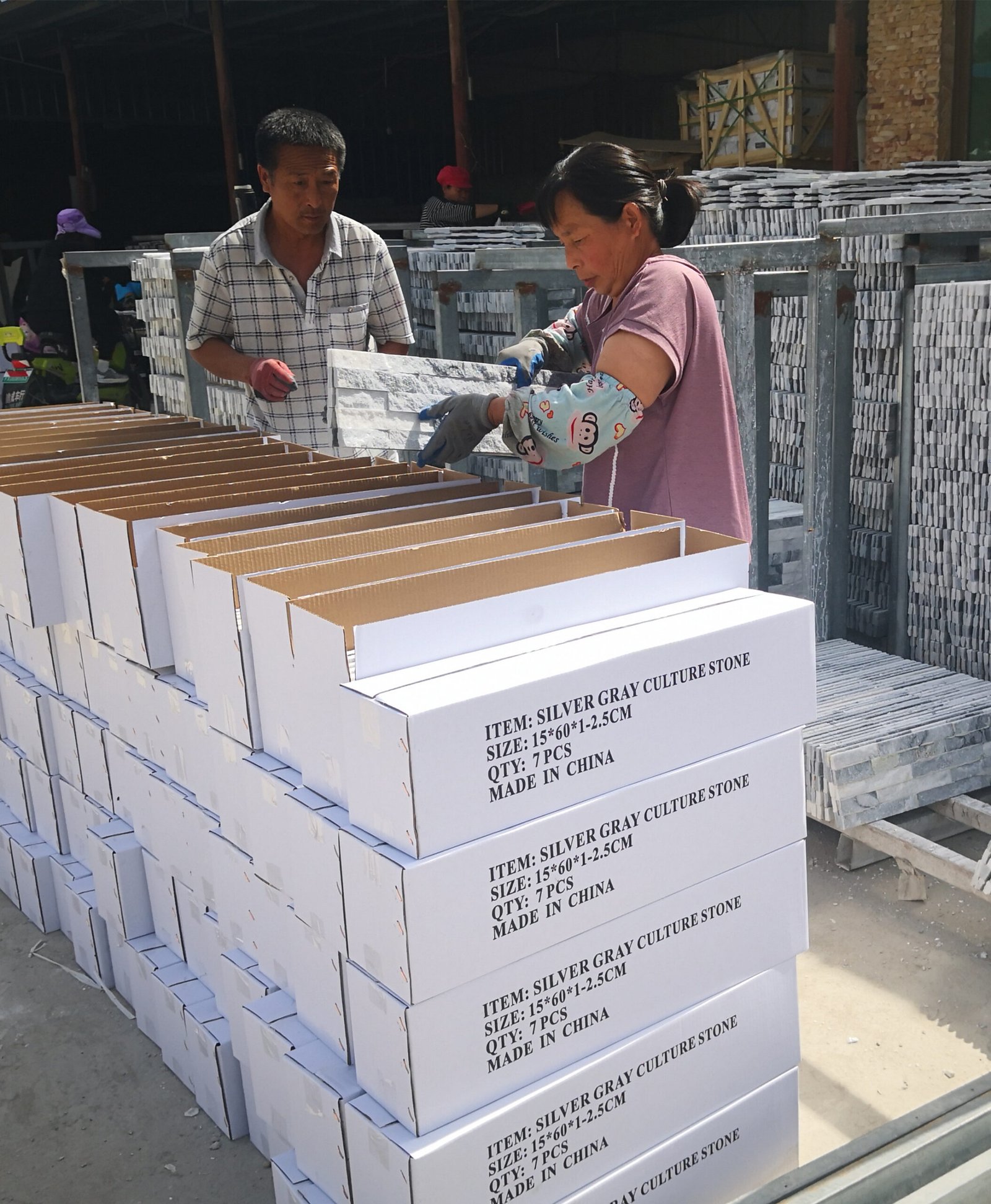 Quality control inspection and inner carton packing of natural stone veneer panels for export shipment at Top Stone Panels factory