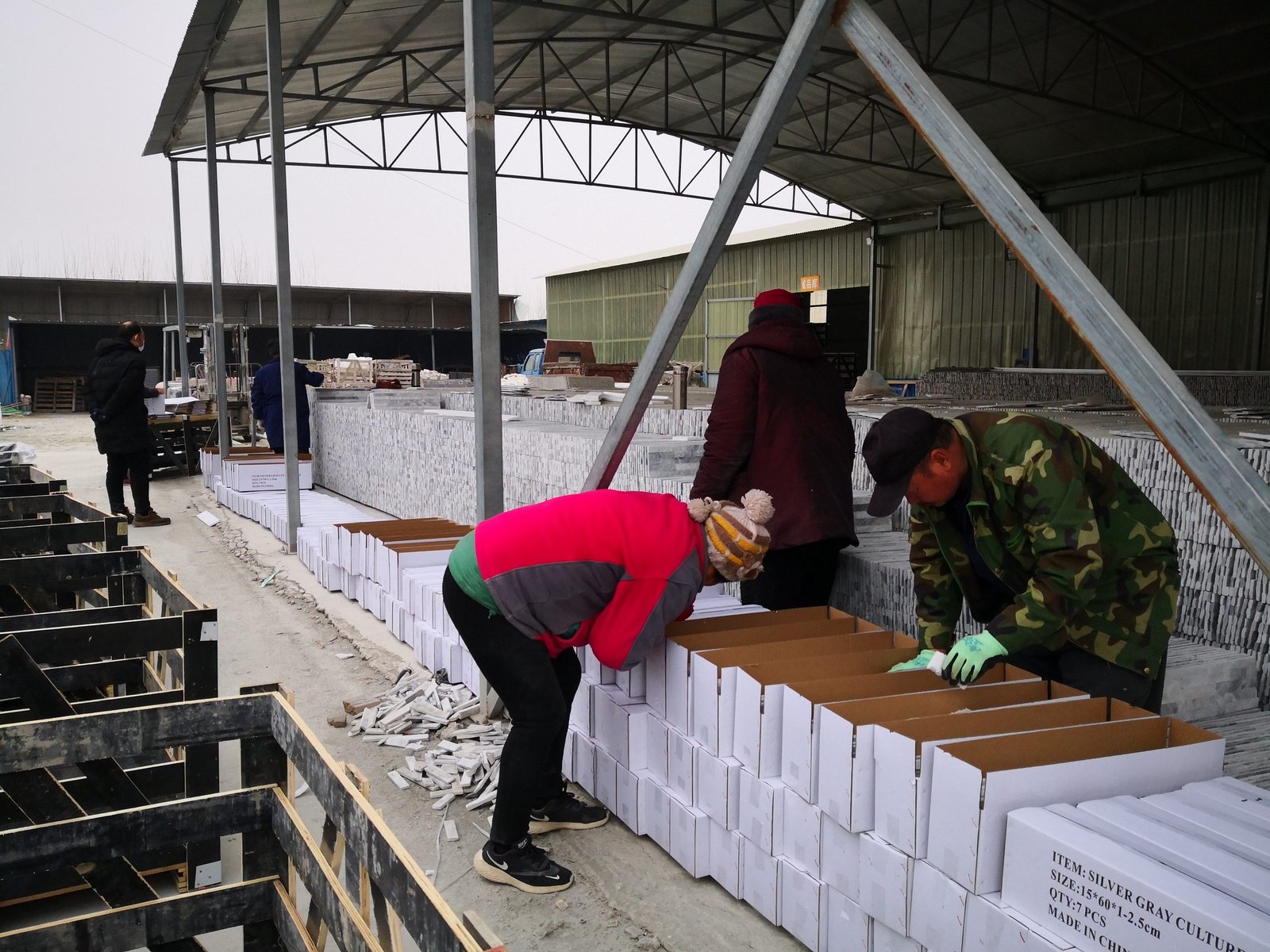 import stone EU - quality control and packing of stacked stone veneer into cartons at Top Stone Panels, the QC trail behind an EU container order