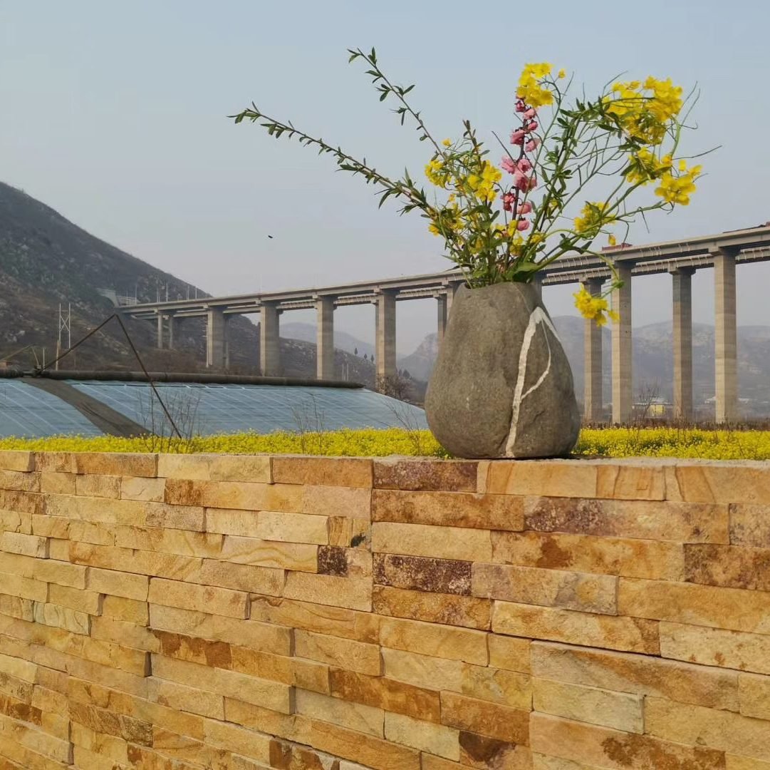 Residential exterior wall clad in natural stone veneer panels