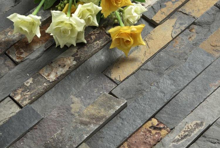 outdoor stone island - natural stone cladding application on an outdoor wall, showing the weatherproof stacked stone treatment used for outdoor kitchen islands