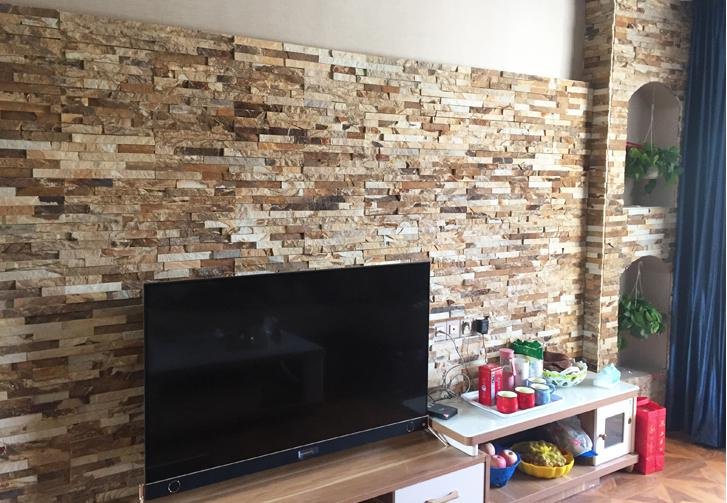 stacked stone application - staggered stone veneer panels installed row by row on an exterior wall