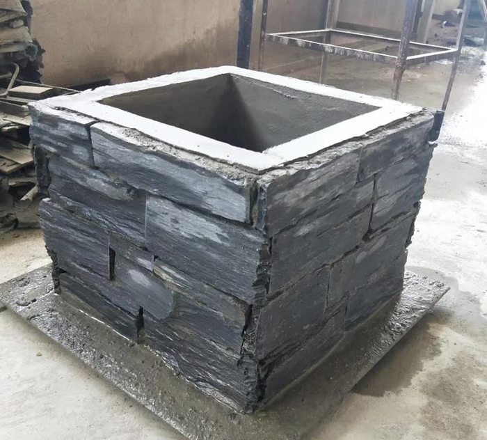 Finished stacked stone column with cap at commercial entrance