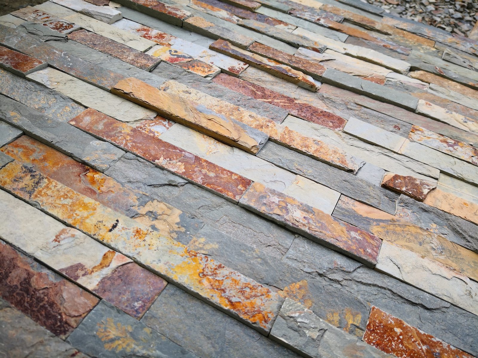 dry stack stone veneer texture - close-up split face slate ledger panel with tight unfilled joints, the mortar-free detail of dry stack stone panels