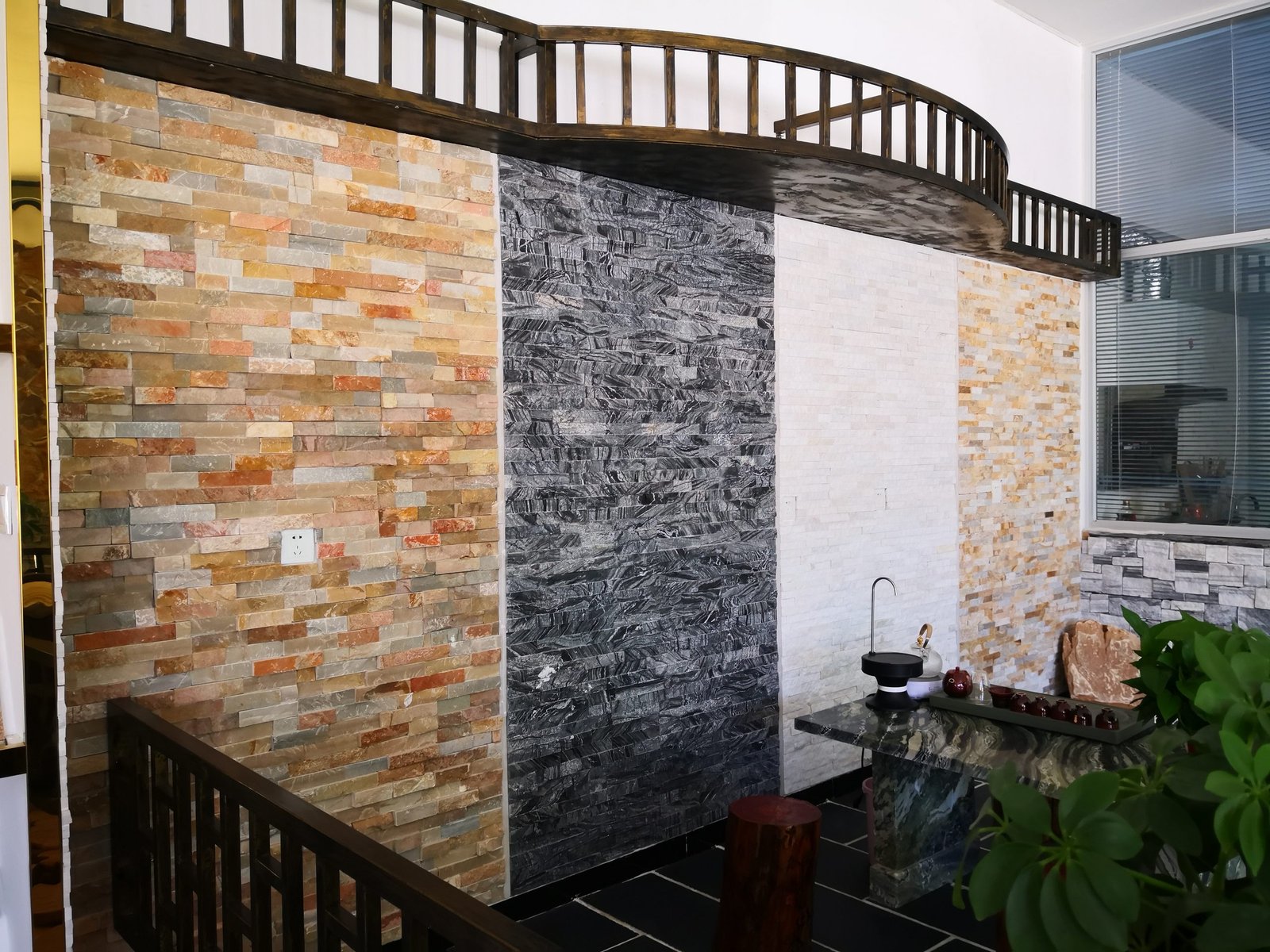 stacked stone ledger panels samples in showroom showing multiple stone types and weights for comparison