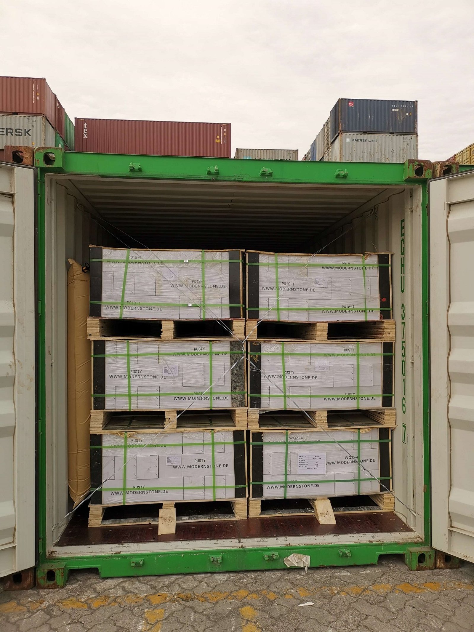 Stacked stone panels on plywood pallets ready for container shipping