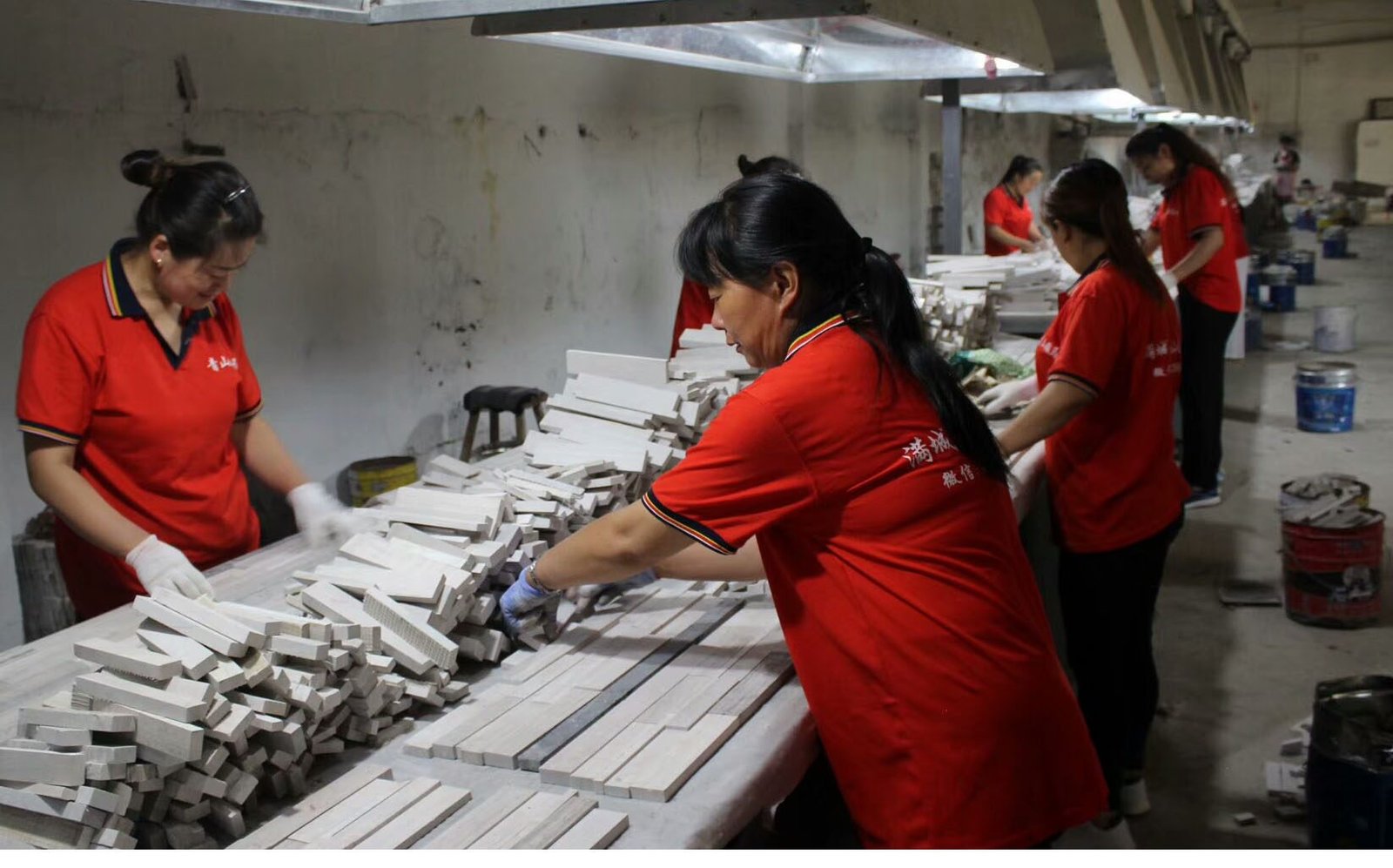 Workers hand assembling natural split face stone panels with 10+ years experience