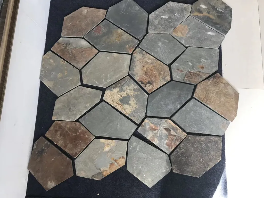 Close-up of natural slate flagstone crazy paving showing riven split face texture and random pattern layout on mesh backing