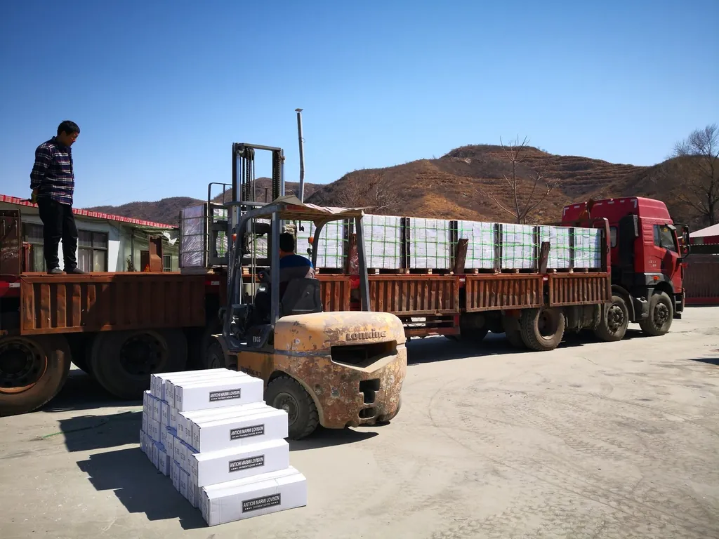 Forklift loading stone pallets for international container shipping