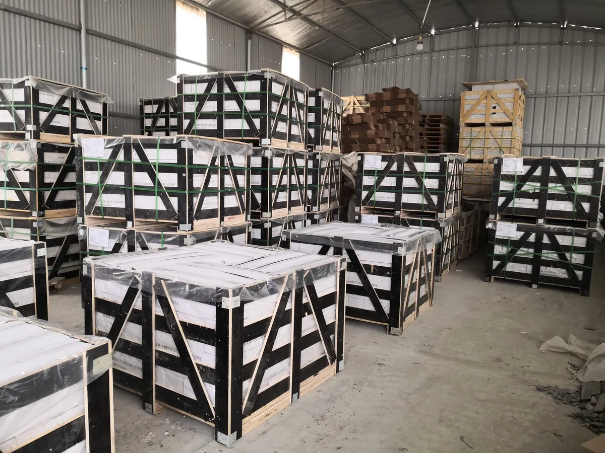Timber export crates with green strapping bands stacked inside a warehouse